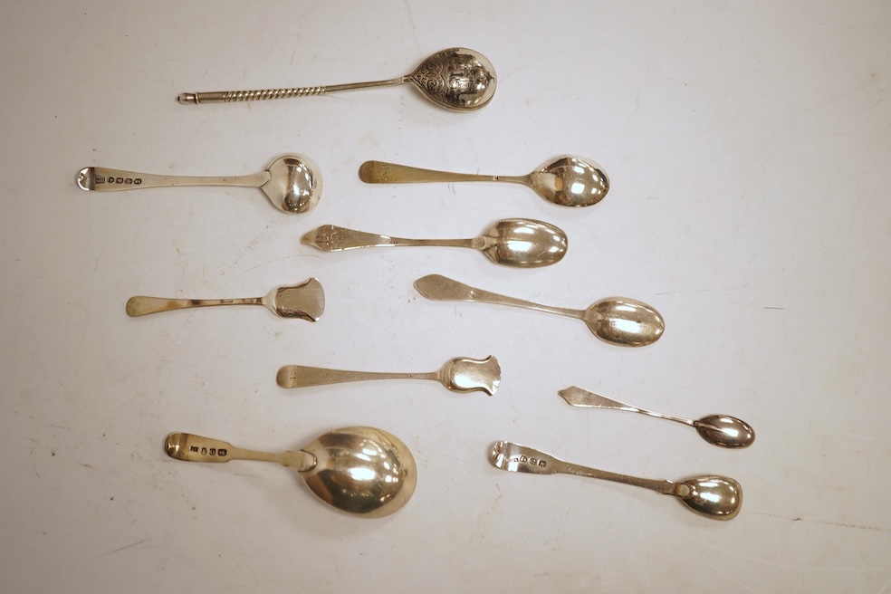 A small collection of nine assorted Georgian and later small silver or white metal spoons, including mustard ladles and other condiment spoons, a caddy spoon, London, 1799, together with a 19th century Russian 84 zolotni